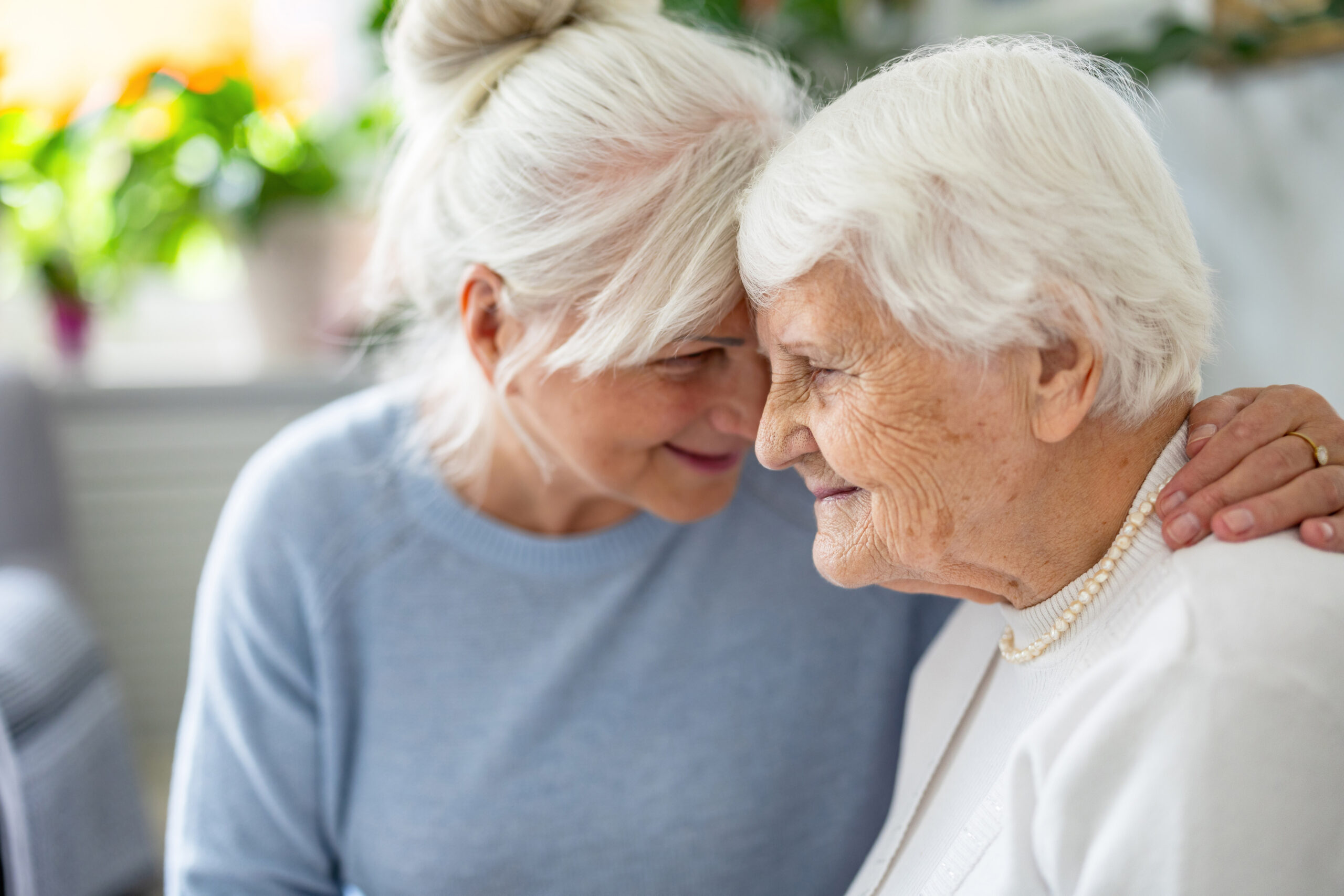 Caregiver embracing an older woman